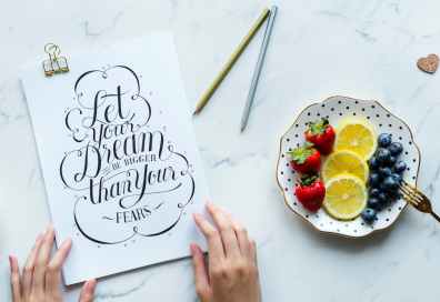 let your dream be bigger than your fears signage beside plate with fruits
